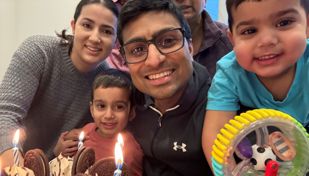 Candid photo of Adil and his family celebrating a birthday.